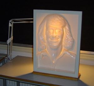 A classic Hollow Face illusion: a concave face mask, lit from inside, that appears to be convex no matter how you view it.